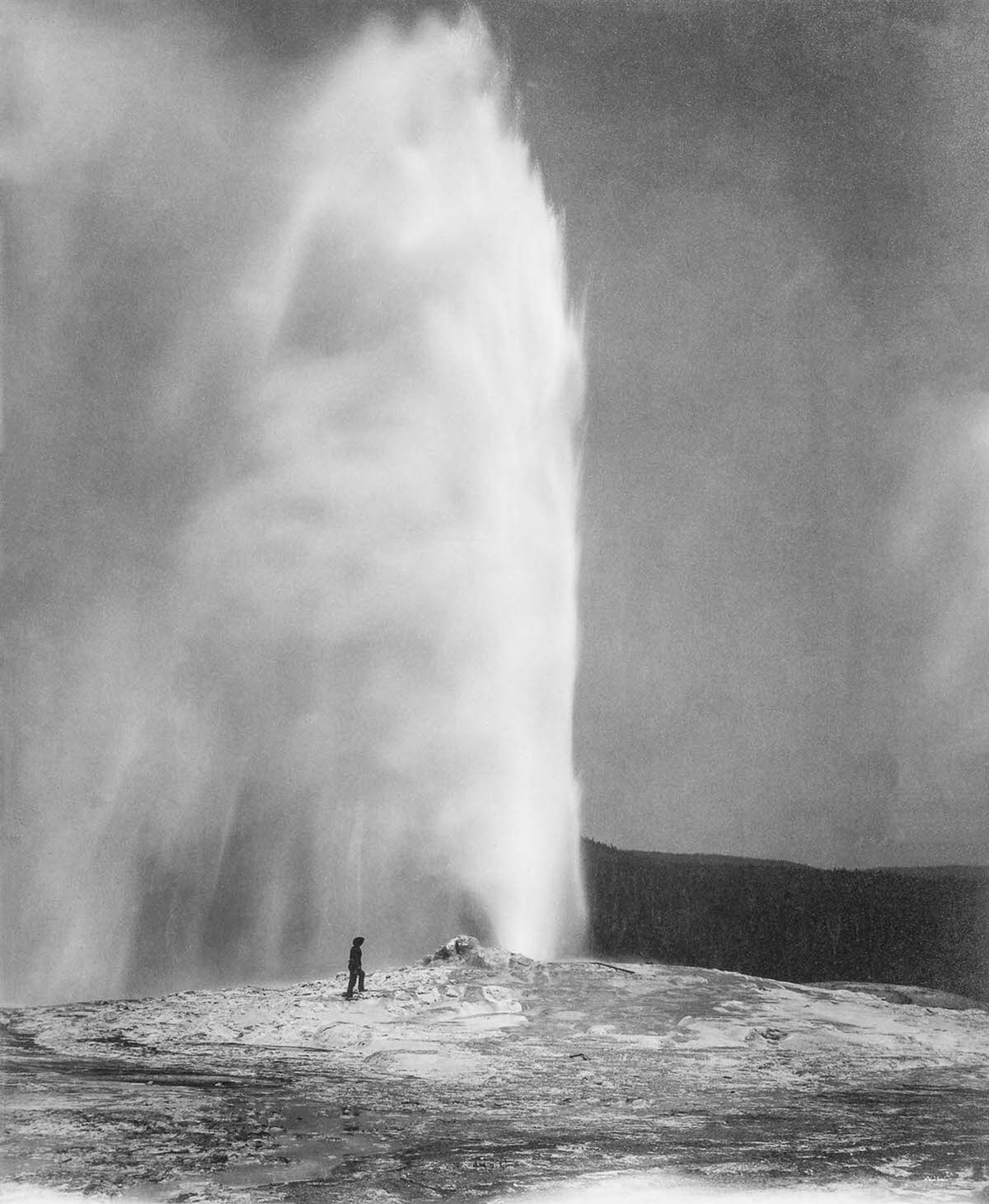 A member of a government geological survey stands next to Old Faithful in Yellowstone, two years before its designation as a National Park, 1870.