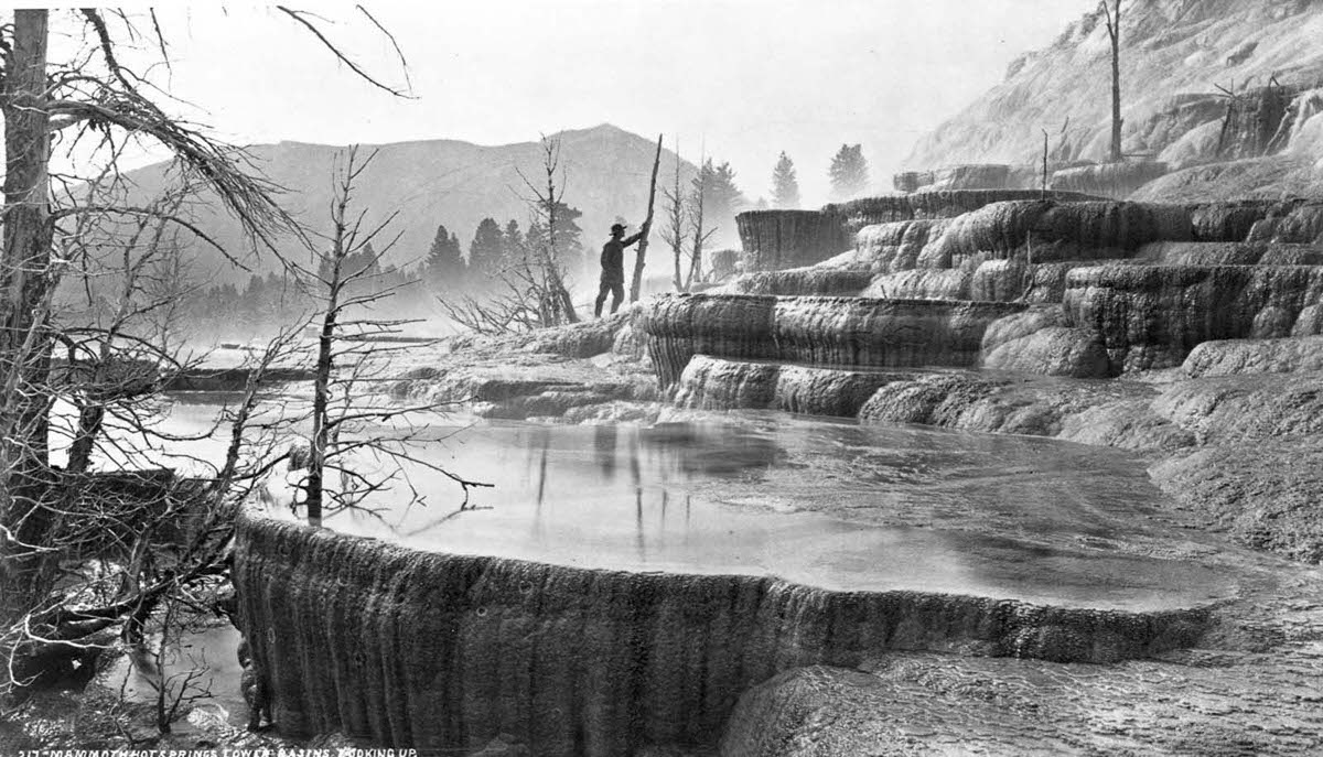 A geological surveyor explores the lower basin of Mammoth Hot Springs in Yellowstone, 1870.