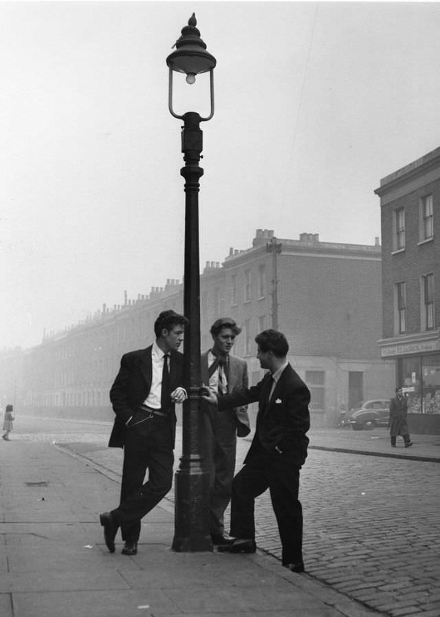 A group of spivs loitering in Notting Hill, London, 1954.