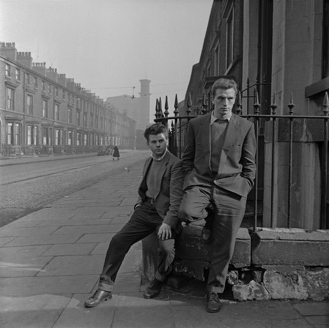 A pair of unemployed teenagers on a street corner, Liverpool, 1957.