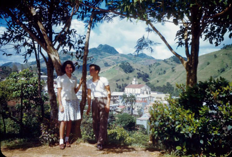 Young couple under tree with Barranquitas, church in background