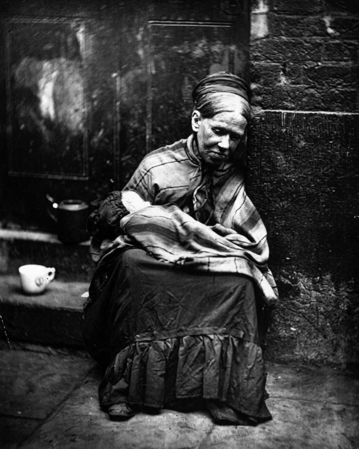 A beggar paid to look after a baby, 1877.