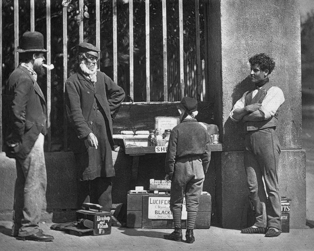A street trader and shoeshine, 1877.