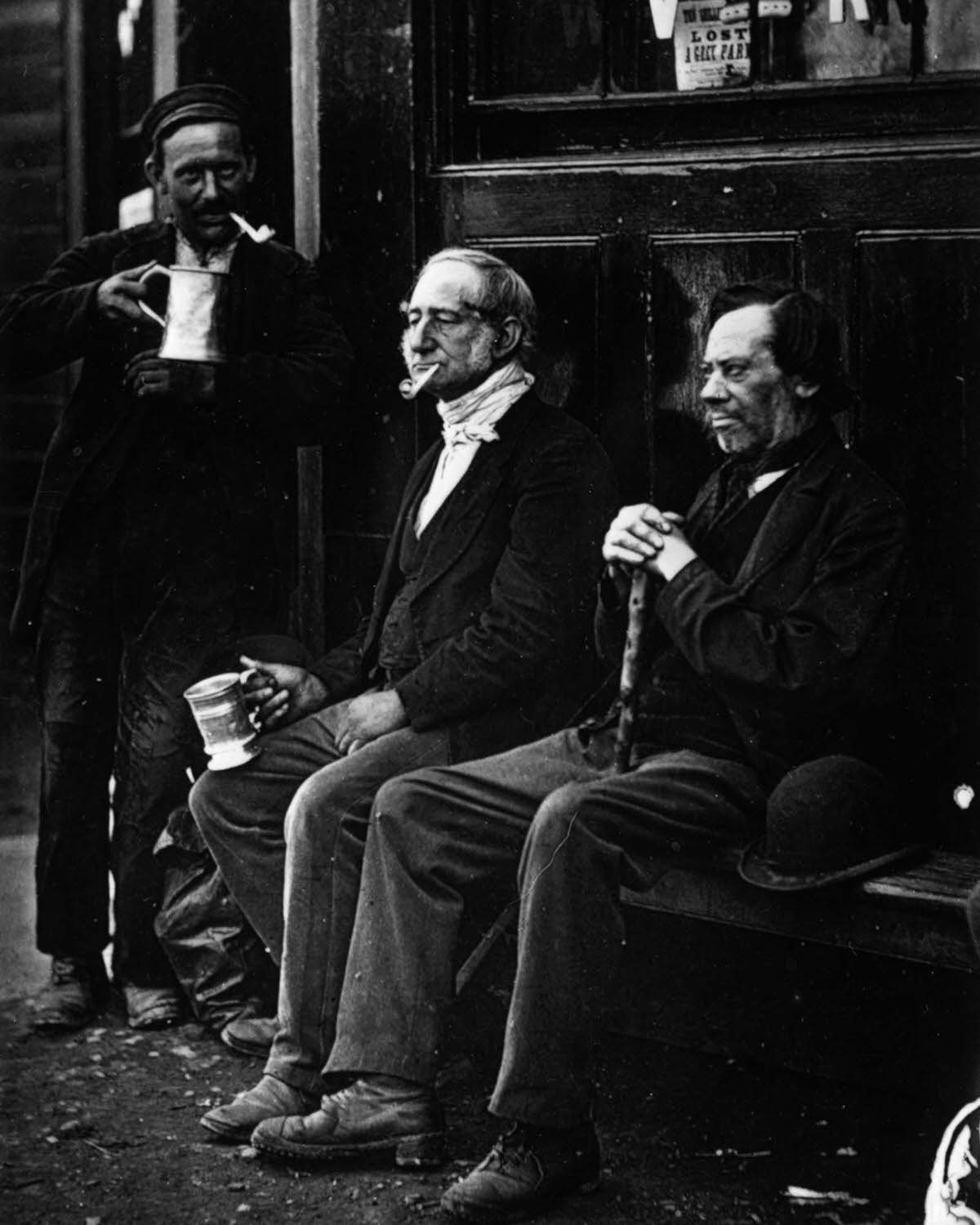 Friends enjoy a beer outside The Wallmaker, a public house, 1877.