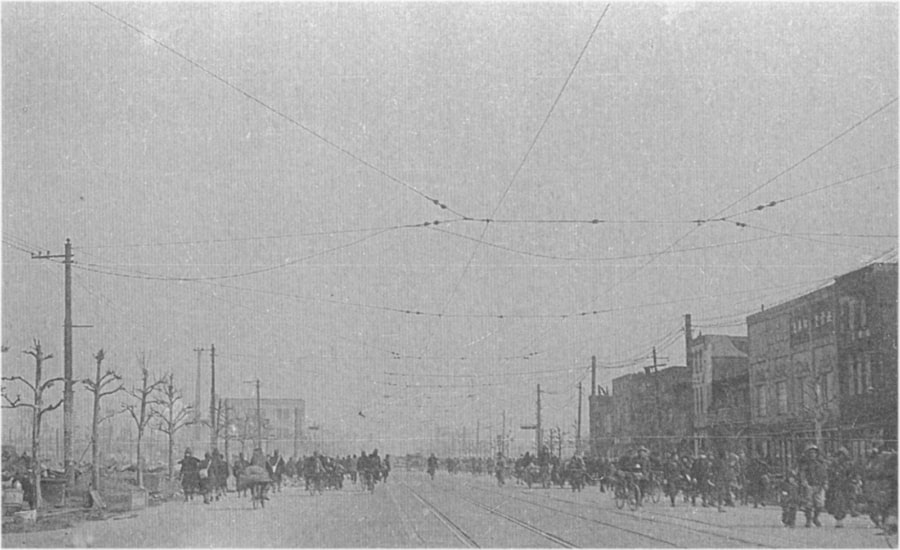 Survivors in Inarimachi amble through the ash-filled streets. March 10, 1945. Tokyo, Japan.