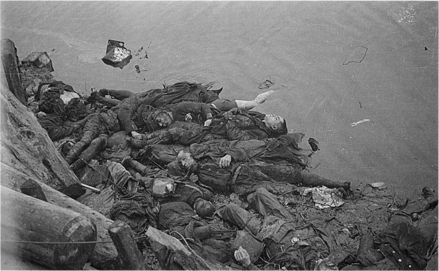 Piles of dead bodies that were blown into the river near Kikukawa Bridge in the Honjo exchange district. March 16, 1945. Tokyo, Japan.