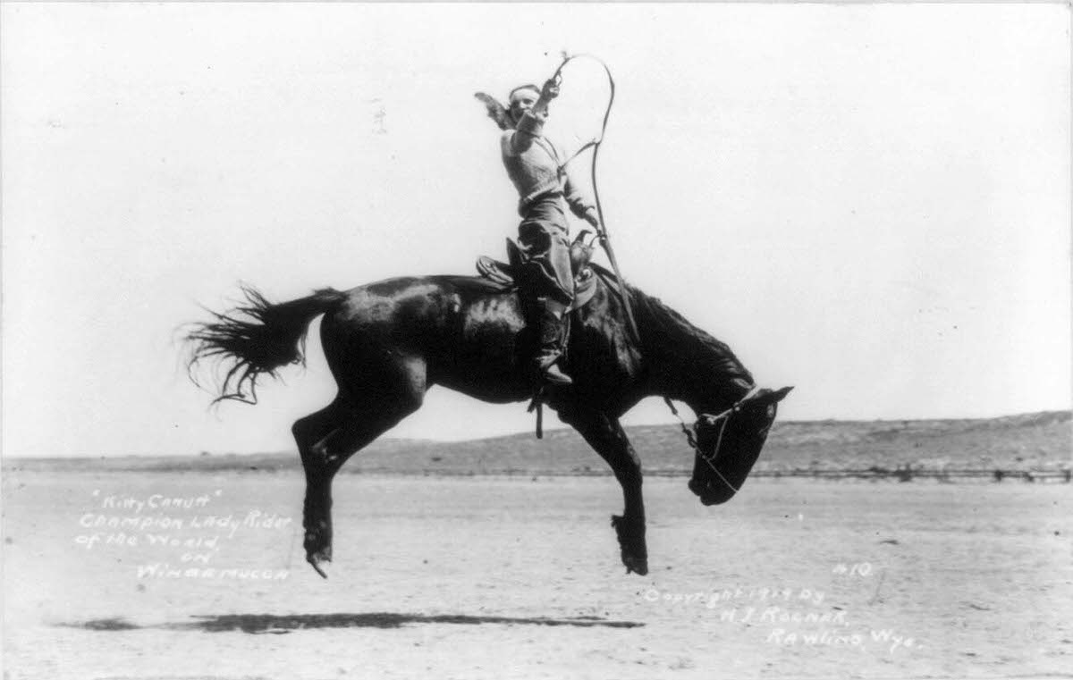 Kitty Canutt, “champion lady rider of the world on Winnemucca,” on a bucking bronco, in 1919.