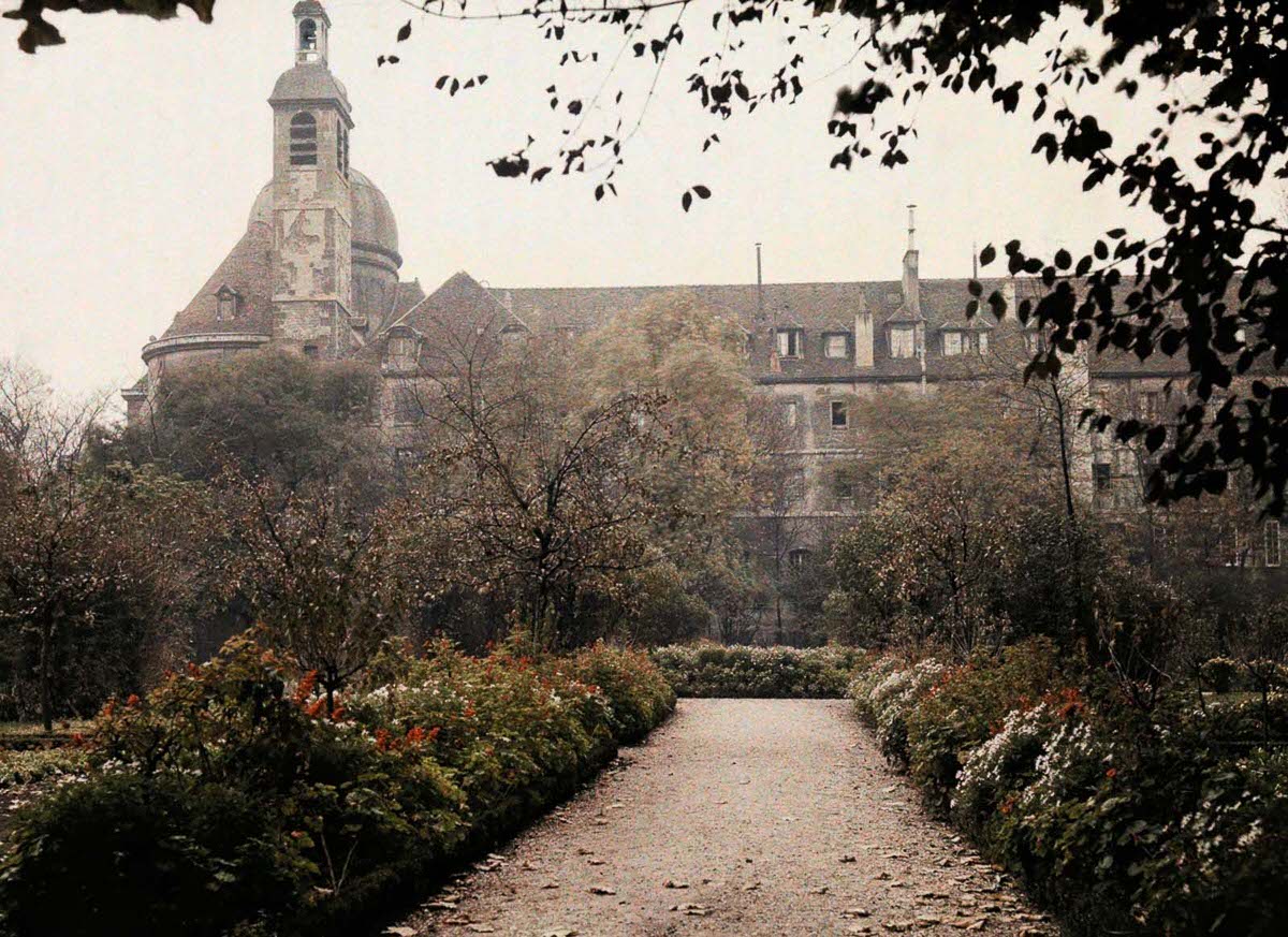 A pathway in the gardens of a large estate.