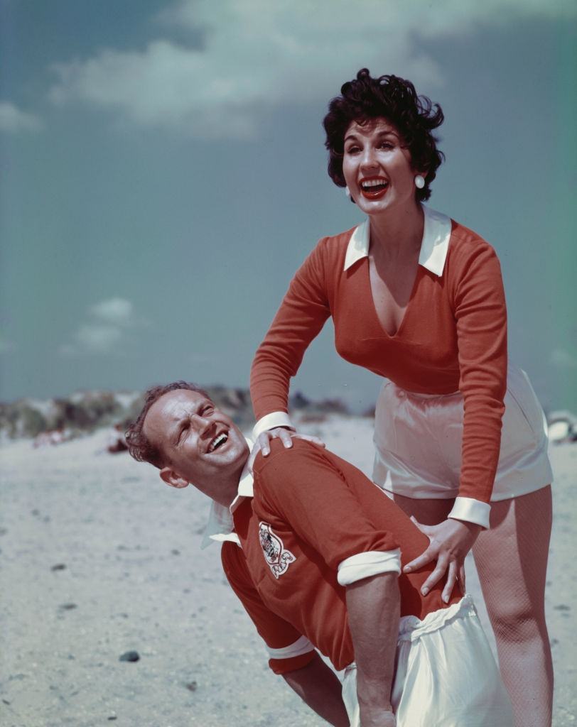 English singer Alma Cogan with English footballer and captain of Blackpool FC, Harry Johnston on Blackpool, England in August 1955.