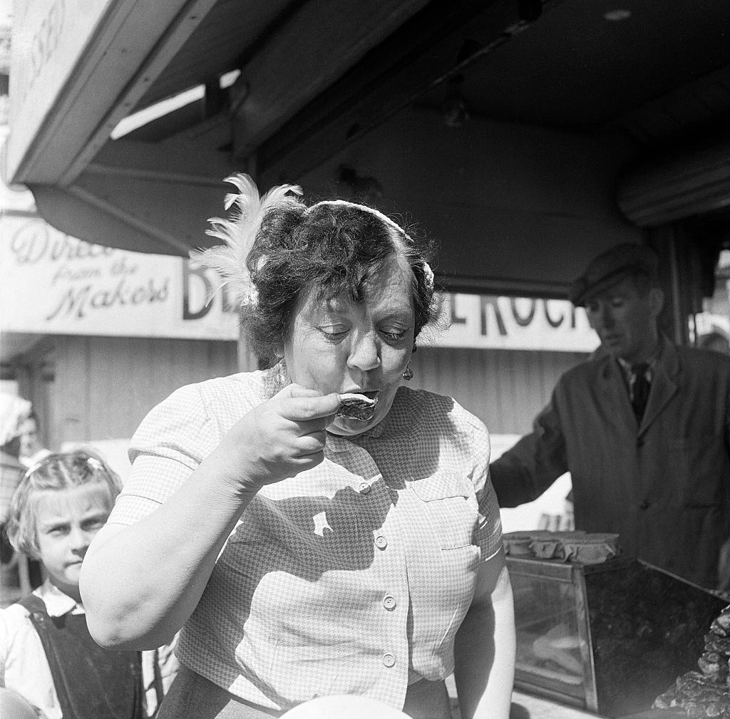 A woman eating oysters whilst on holiday in Blackpool, 3rd August 1953.