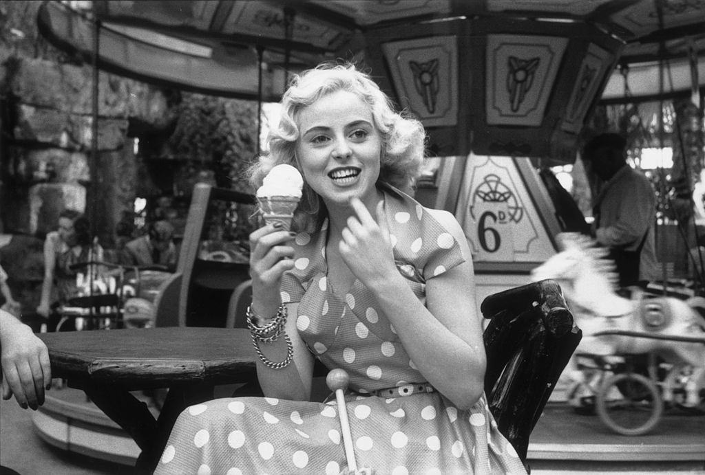 Tourists enjoy ice creams at the fairground in the seaside resort of Blackpool, 1953.