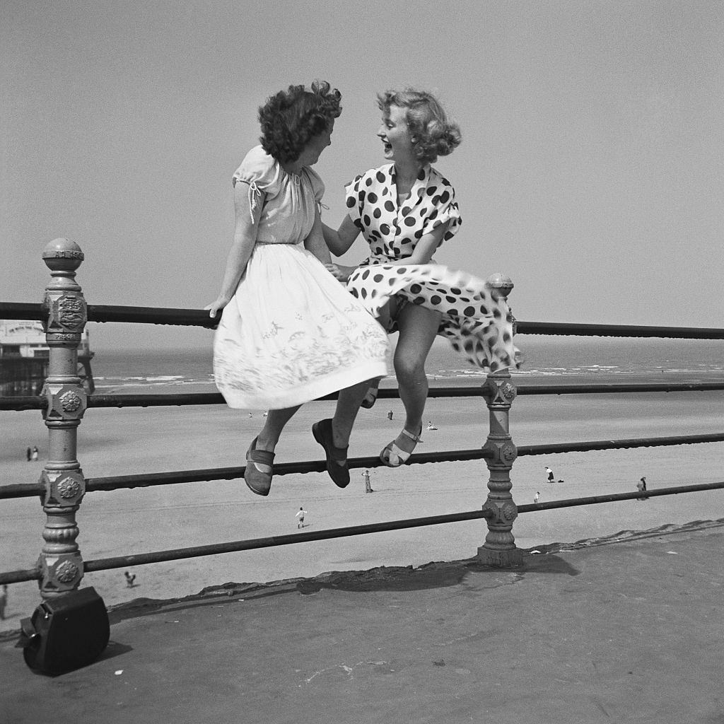 wo women chatting on the railings in Blackpool, 1951.