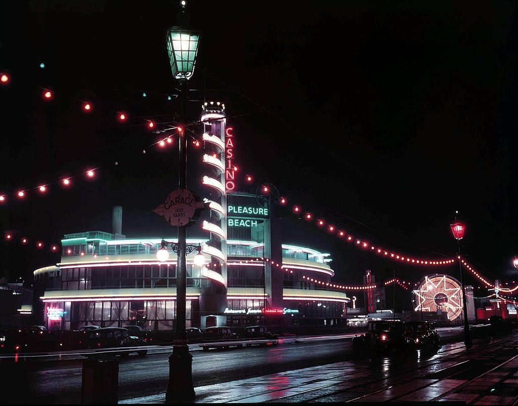 View of the casino and pleasure beach buildings lit up during the Blackpool Illuminations annual lights festival in the seaside resort of Blackpool, 1950.