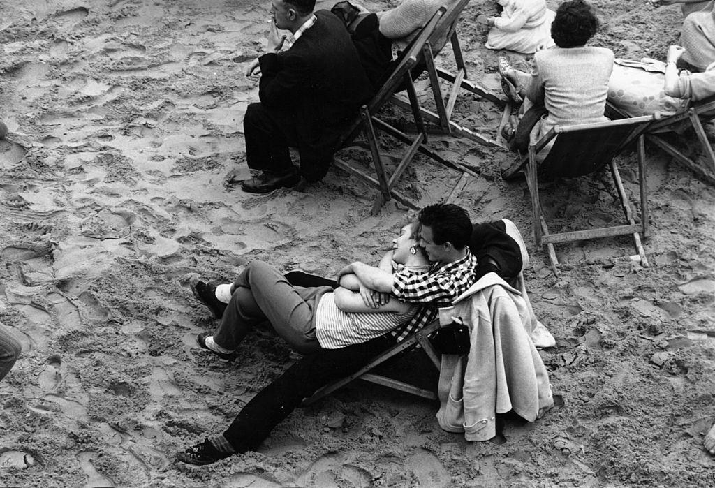 A couple relax on Blackpool beach, 1956.
