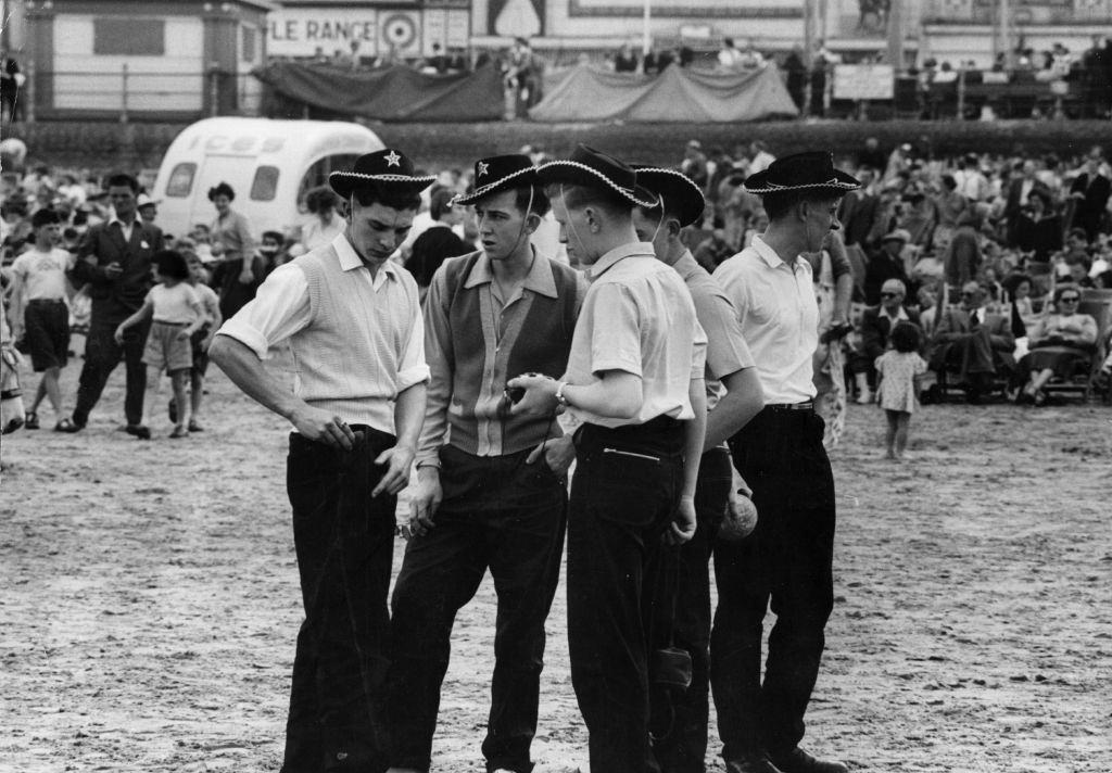 A group of teenagers in cowboy hats on the beach at Blackpool, 1956.