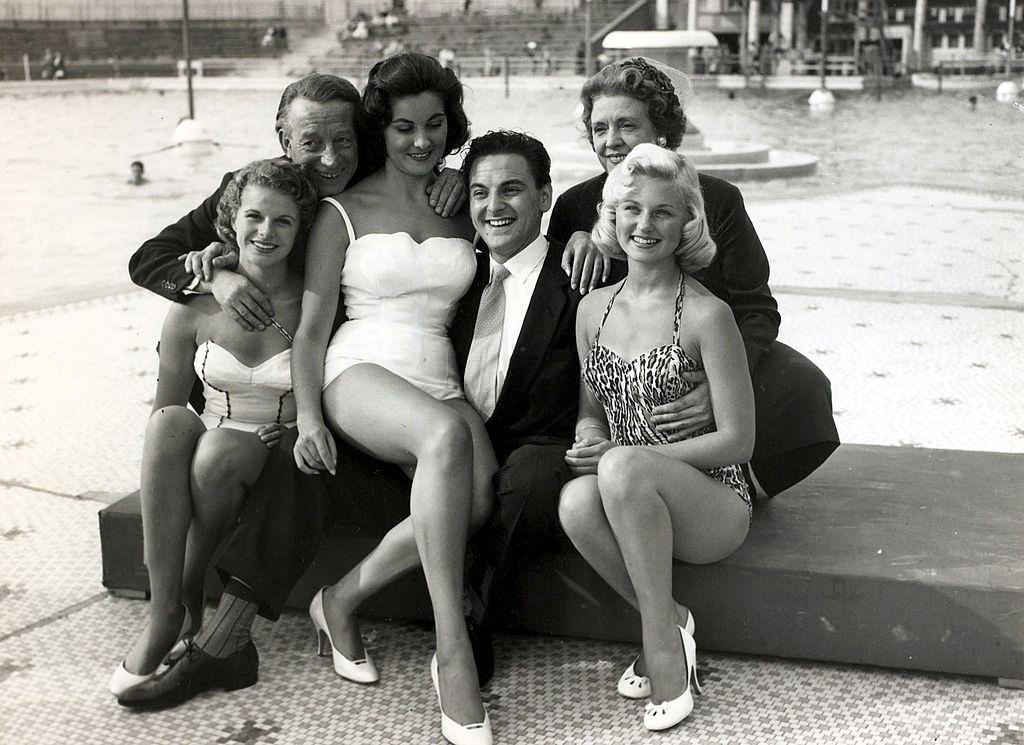 British comedian Bob Monkhouse, centre with Wilfred and Mabel Pickles and beauty contestants at a beauty show at Blackpool, 1957.