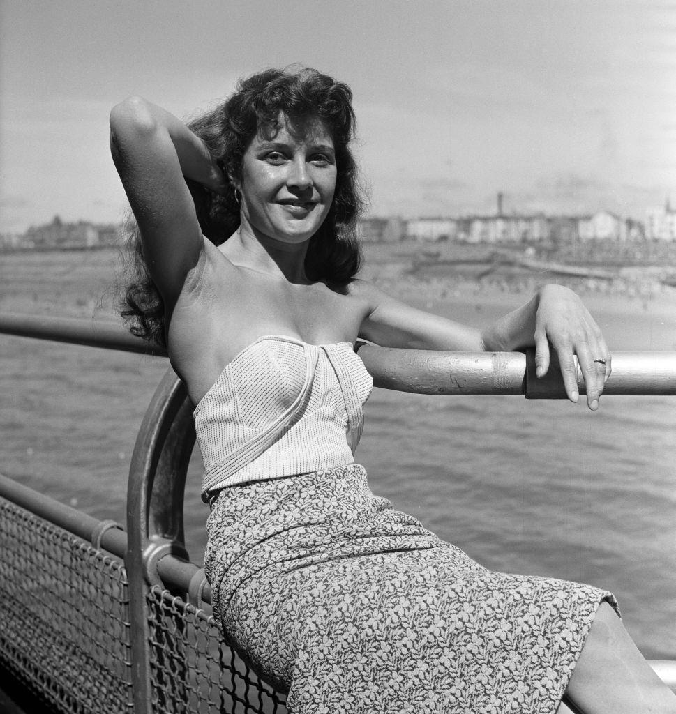 A 22-year-old Veronica Cliff sitting on the rails at Blackpool, 1958