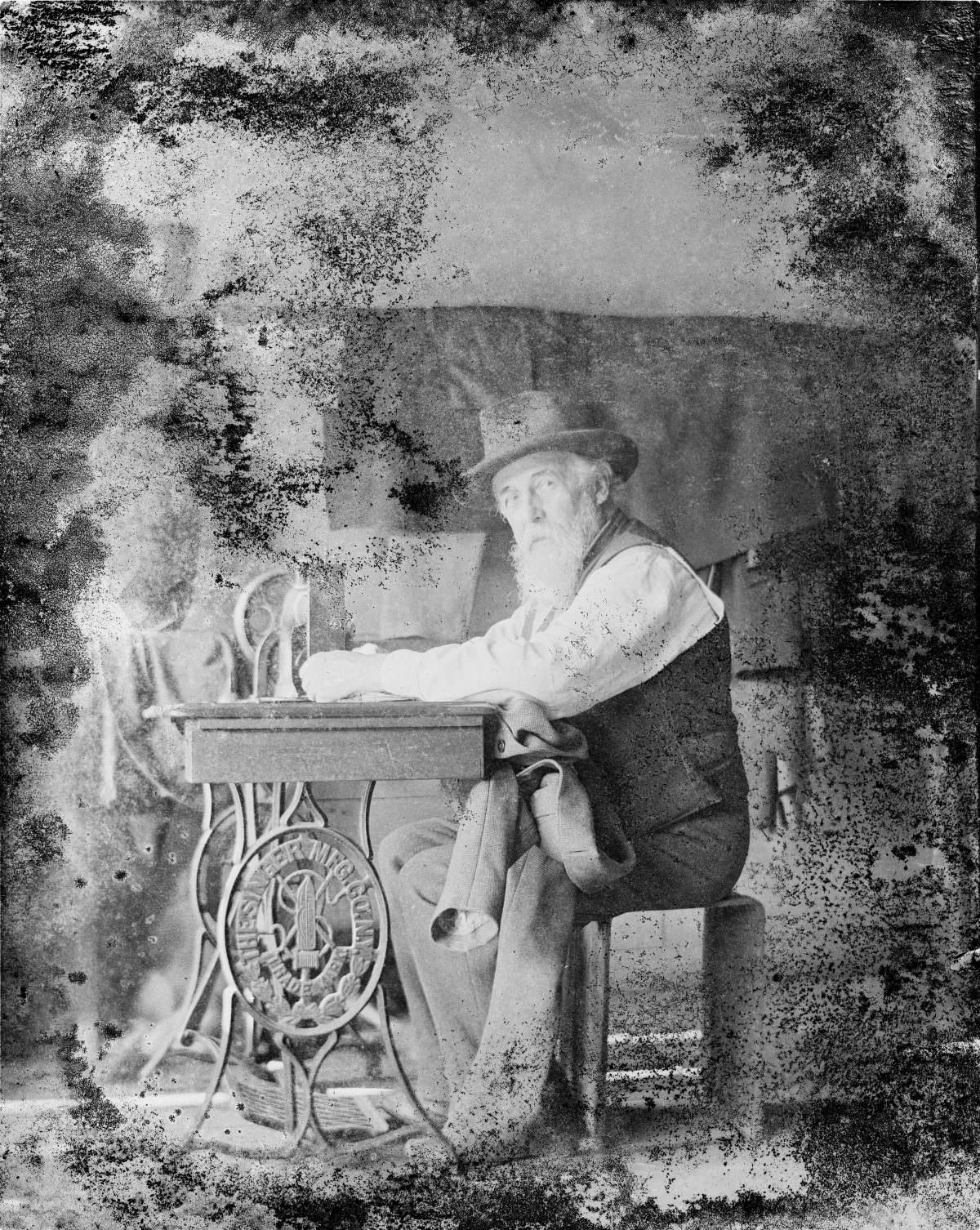 Man working at sewing machine – George Silas Duntley Photographs 1899-1918