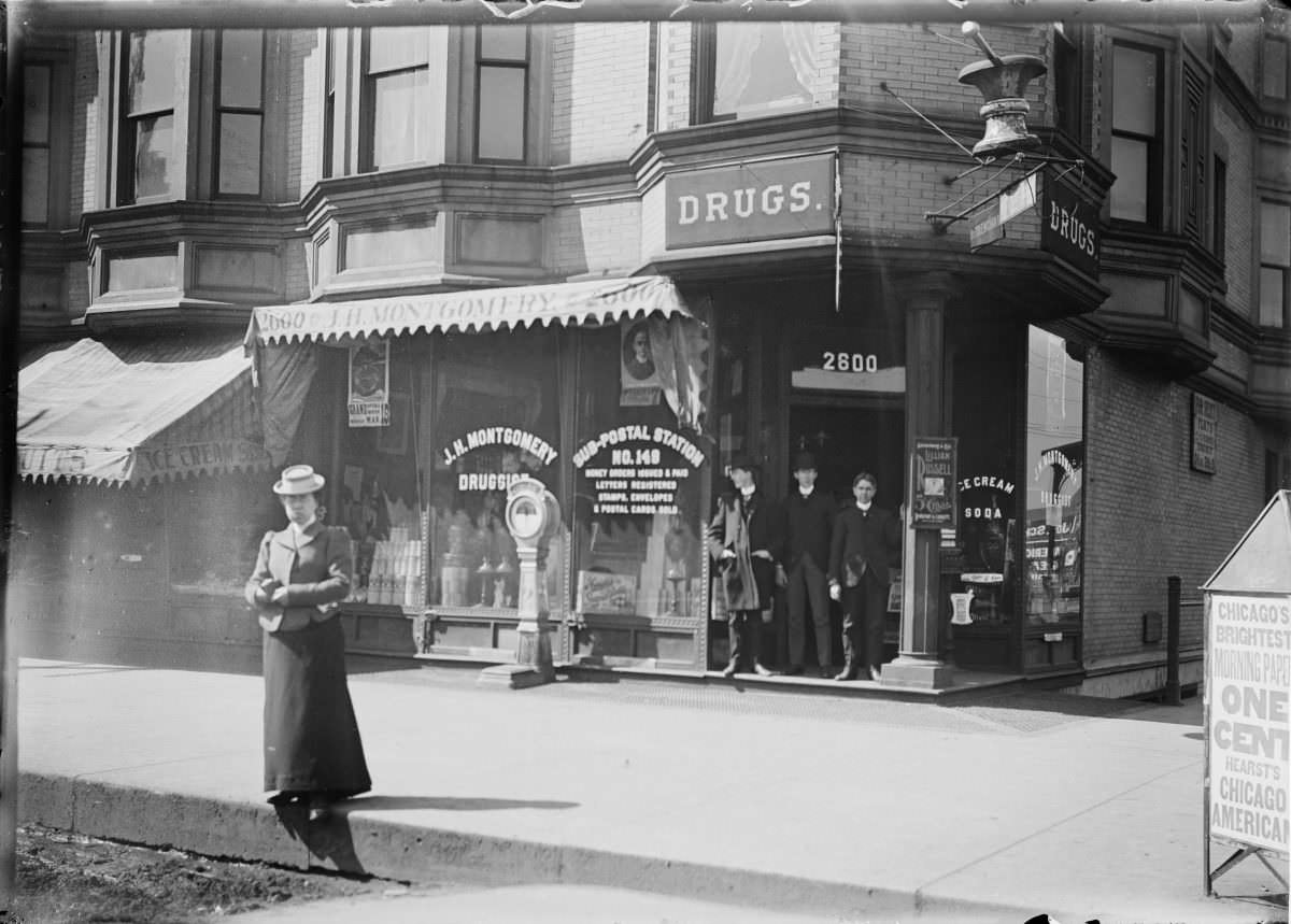 Unidentified men and woman standing at the entrance to J.H. Montgomery Drugs, Sub postal station – George Silas Duntley Photographs 1899-1918