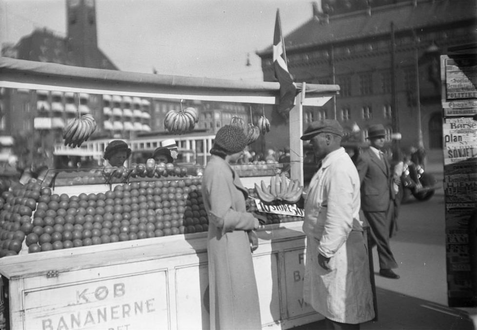 Woman buys bananas at a fruit stand