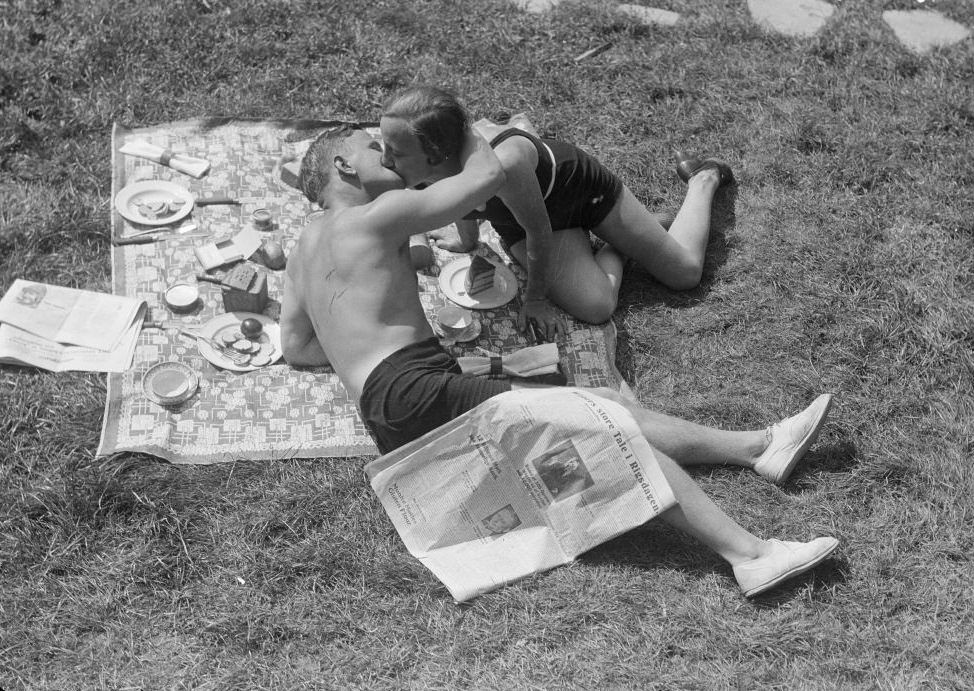 Young couple kissing on a picnic