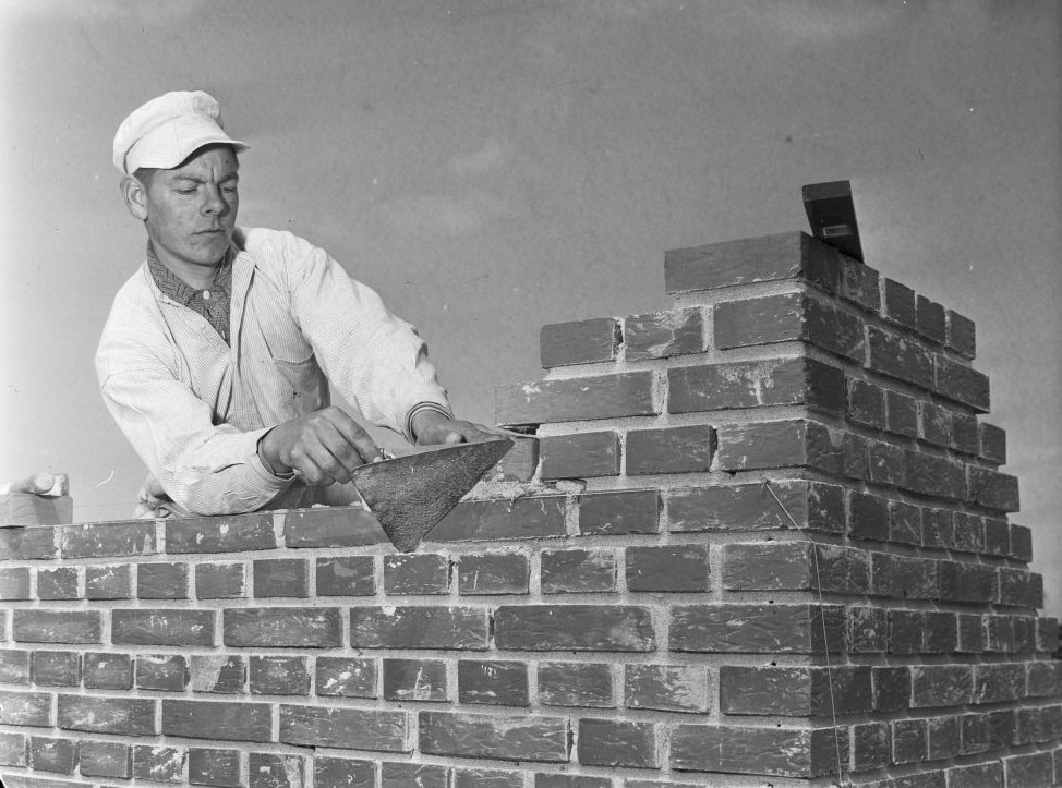 Bricklayer with a bricklayer's trowel