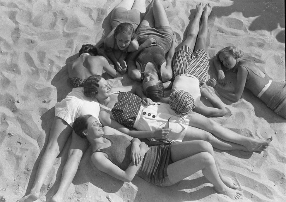 4Girls lying on the beach