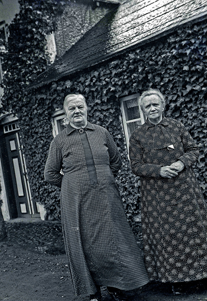Two old ladies stand in front of their house in Denmark, 1937