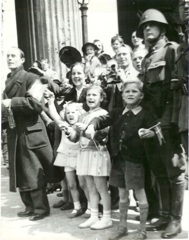 Enthusiastic people with flags outside Vor Frue Kirke in Copenhagen. May 1945