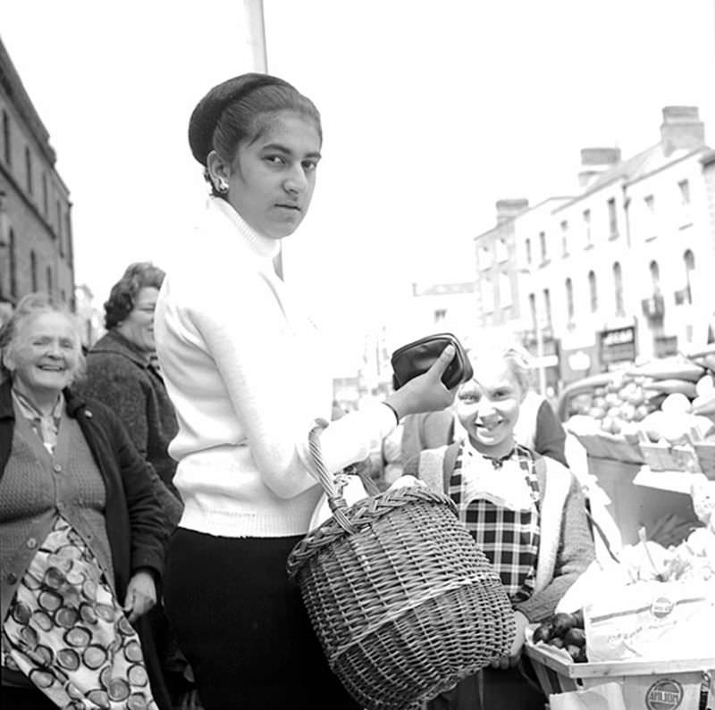 A very direct stare from a woman shopping on Moore Street, Dublin, 1964