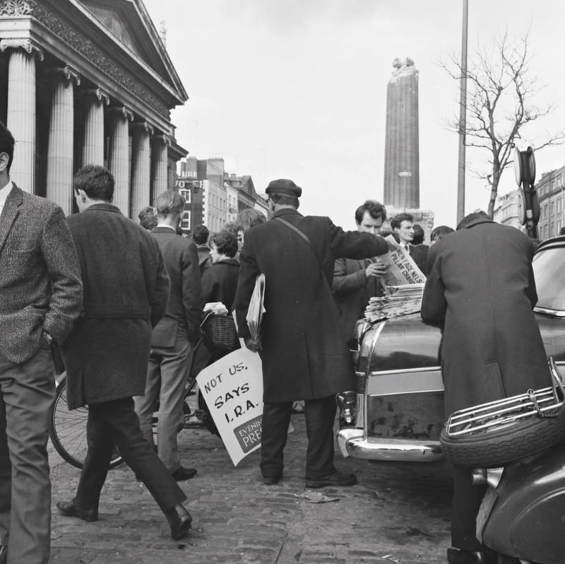 An Evening Press newspaper seller does a brisk trade on O'Connell Street, Dublin on the day after Nelson's Pillar was blown up, March 9, 1966