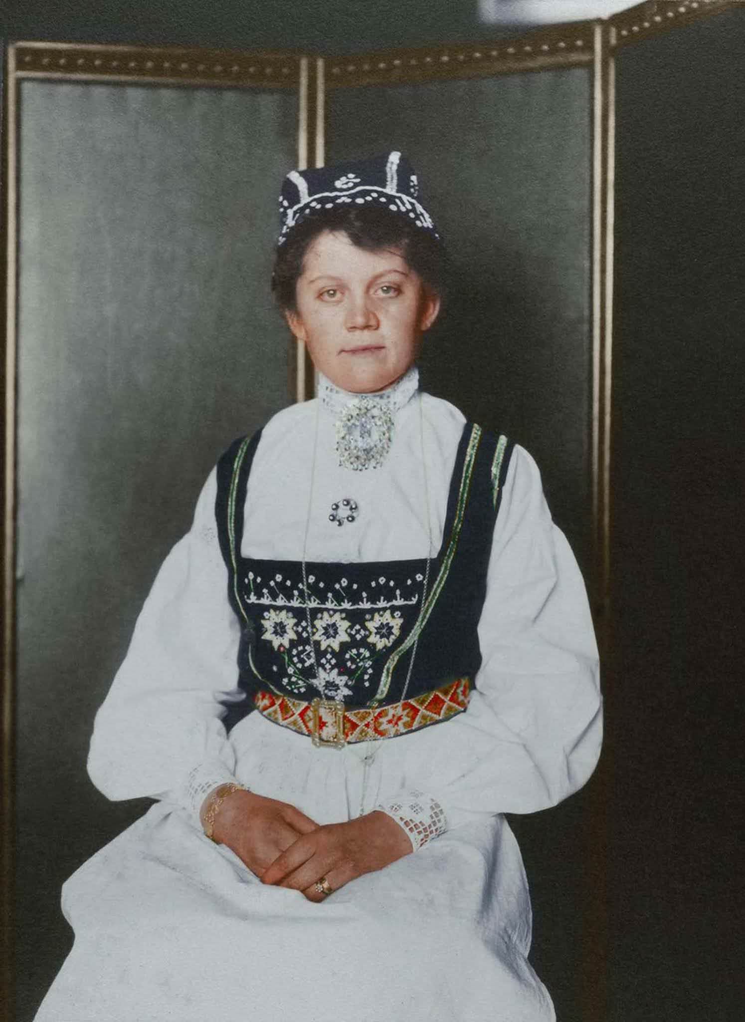 Norwegian woman.” Bunad is the umbrella term encompassing Norwegian traditional dress that is distinctly Norwegian, though the costumes themselves like so many others are influenced by region, tradition, and available material. In rural Norway, clothes were often made at home and typically made from