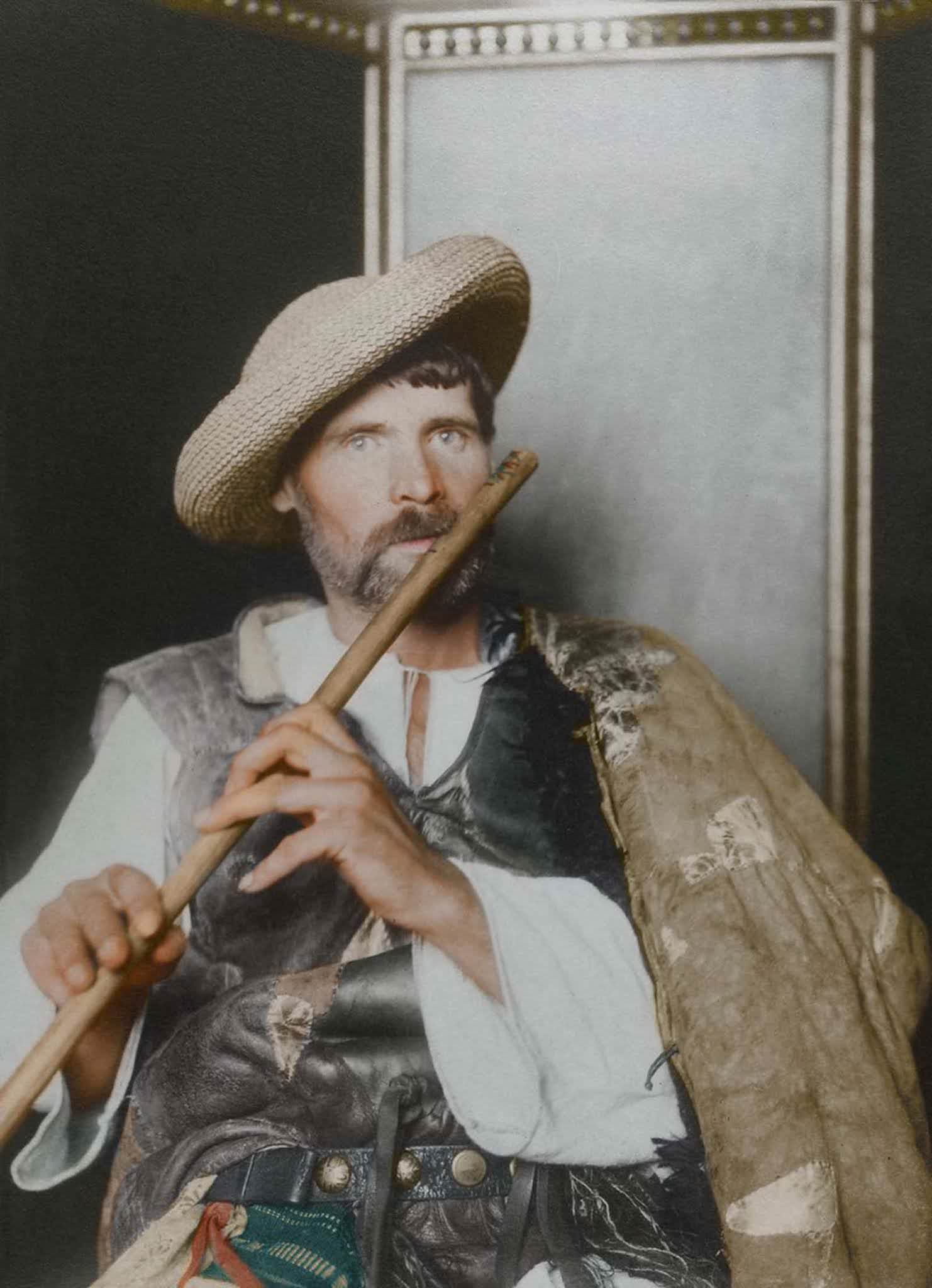 Romanian piper.” This particular cojoc, an embroidered sleeved sheepskin coat, is much plainer than the shepherd’s version, making it a more practical, work-oriented coat, suggesting that the subject is of the working class given the lack of decoration and the straw hat. The waistcoat, known as a pi