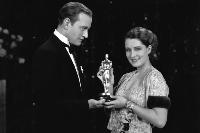 Vice president of the Academy of Motion Picture Arts and Science, Conrad Nigel, presents the Oscar to actress Norma Shearer, 1929