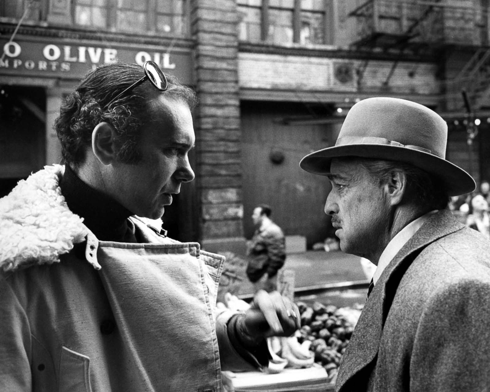 Producer Albert S. Ruddy confers with Marlon Brando on set.