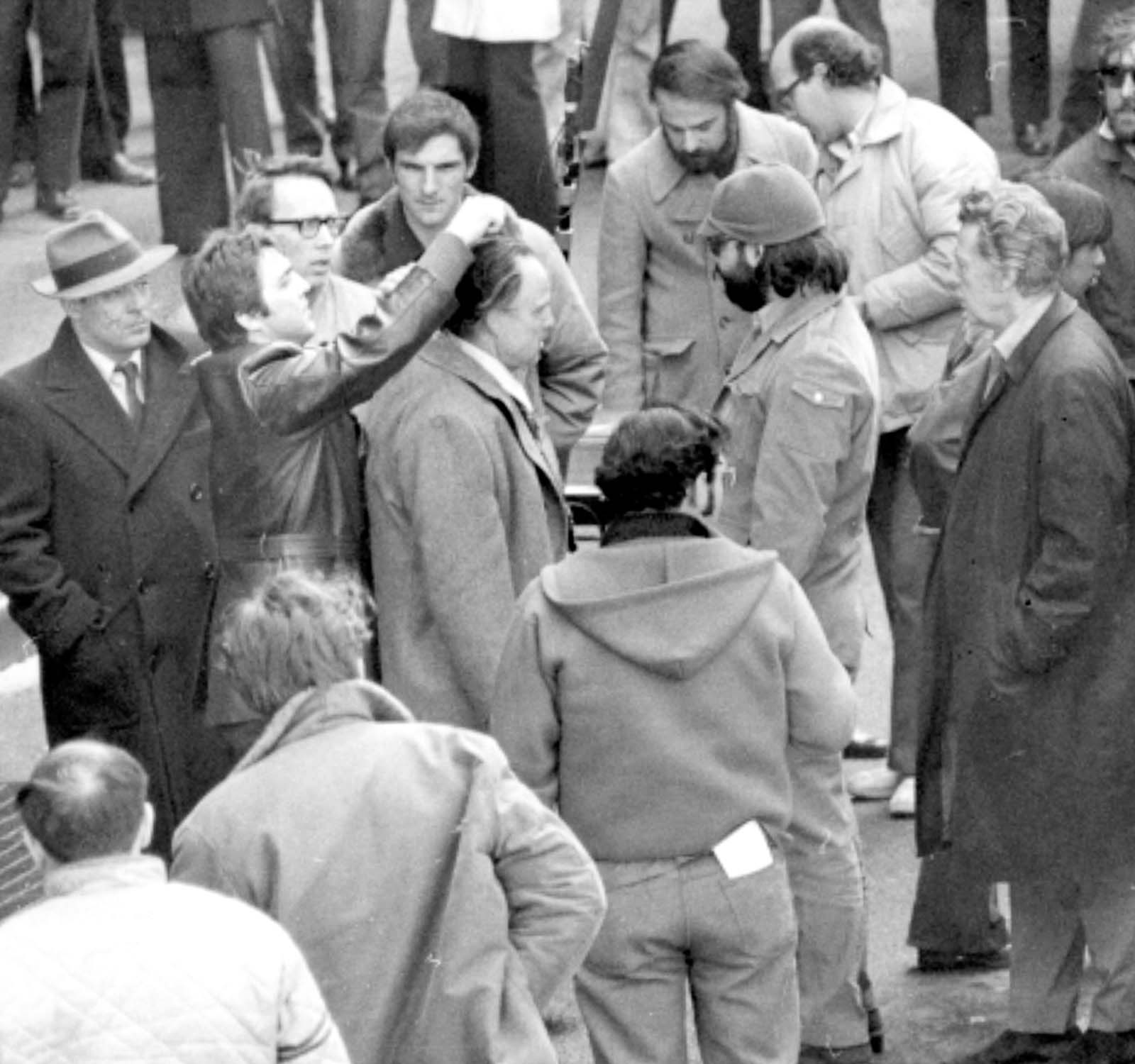 A producer grooms Brando’s hair.