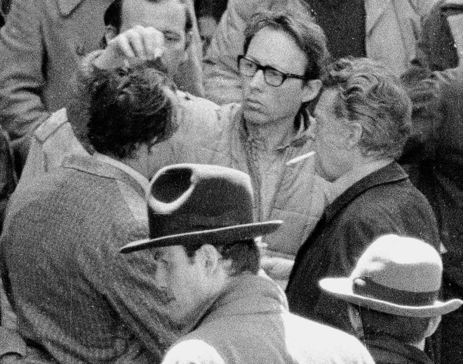 A producer adjusts Brando’s hair.