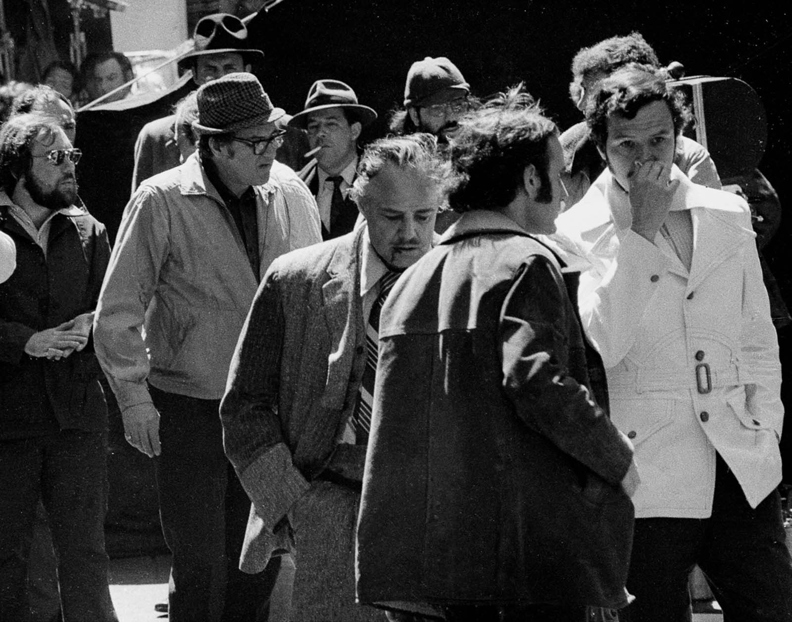 Stage blood drips from Brando’s mouth after a take of the shooting scene.