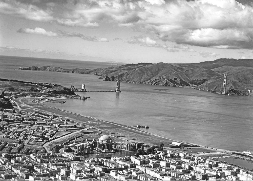 Marina and the Presidio of the Golden Gate Bridge under construction with the Palace of Fine Arts in the lower center, 1935.