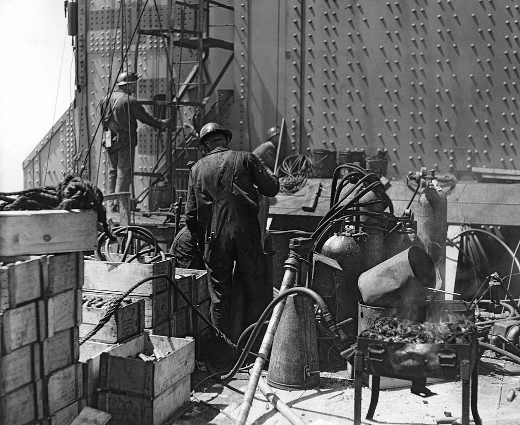 The Golden Gate Bridge under construction with workmen putting the finishing touches on the South Tower, 1935.