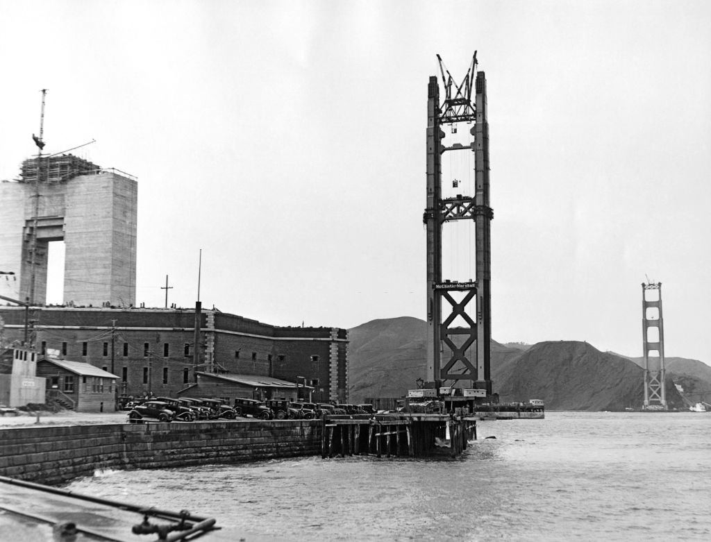 The Golden Gate Bridge under construction with the Pylon #1 and the North and South Towers rising above Fort Point, 1935.