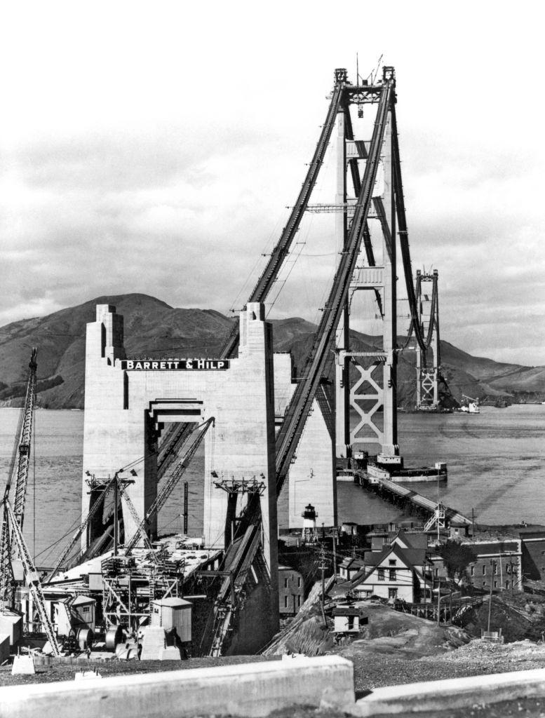 The construction of the Golden Gate Bridge, with the catwalks attached to the cables in preparation of the building of the roadbed, 1935.