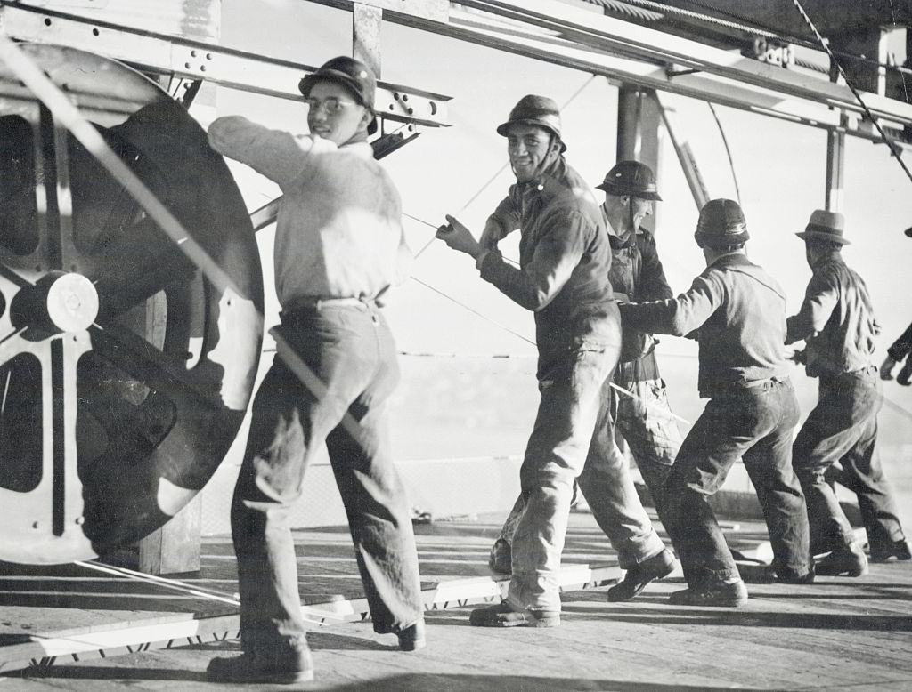 Men on the catwalk cable spinning, 1935.