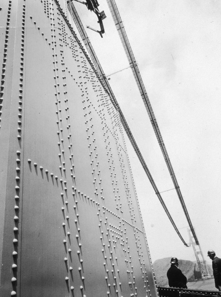 Two construction workers on the Golden Gate Bridge in San Francisco during its construction.