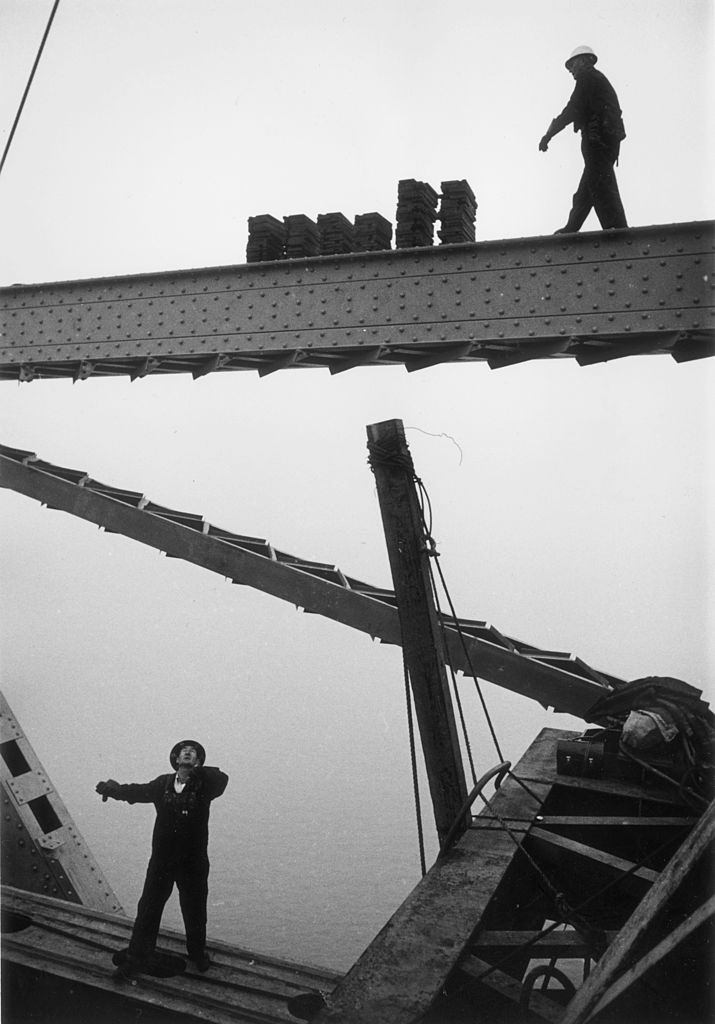 Construction workers crossing a girder during building work on the Golden Gate Bridge in San Francisco.