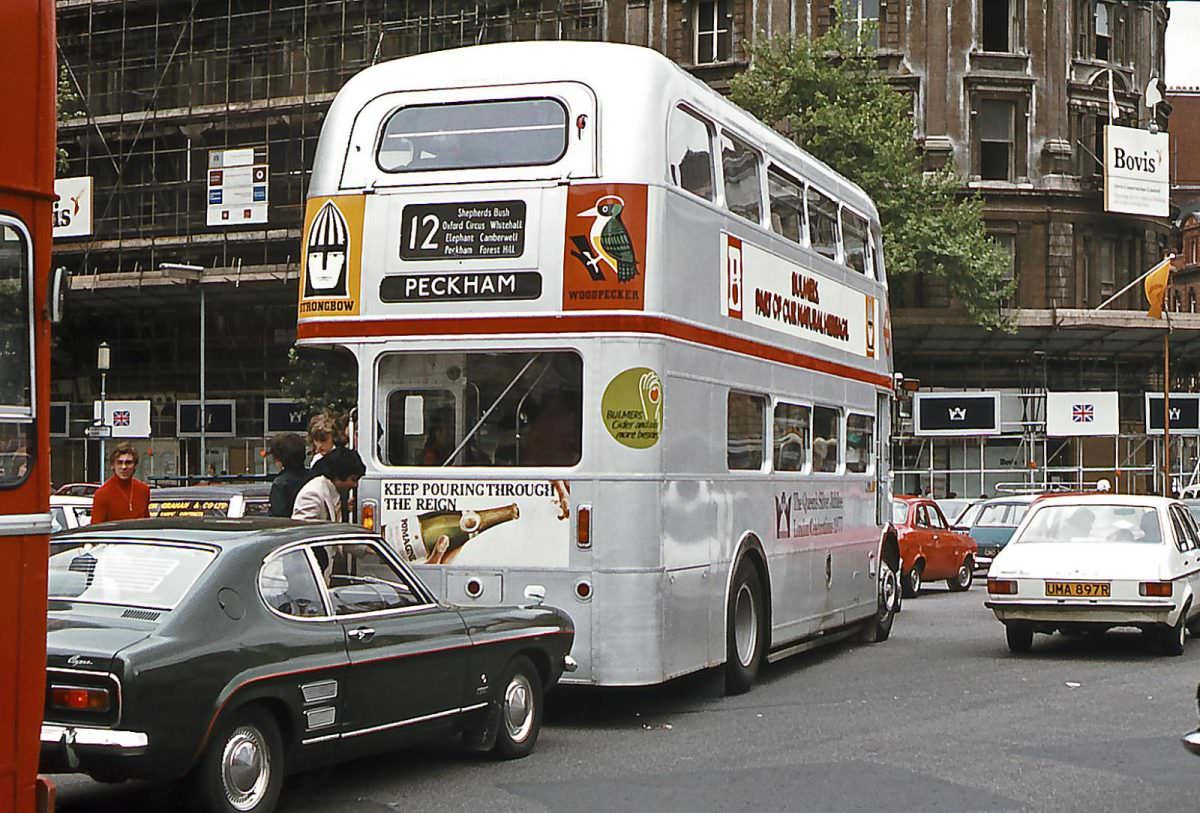 Temporarily renumbered as SRM5, Bulmers Cider sponsored AEC Routemaster No. RM1668 in Queen’s Silver Jubilee livery makes it’s way through Trafalgar Square on 6th June 1977.