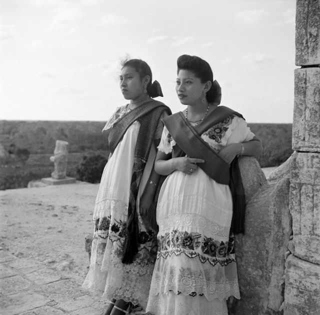 Local women pose at ruins of one of the largest Maya cities of the Terminal Classic in Chichen Itza.