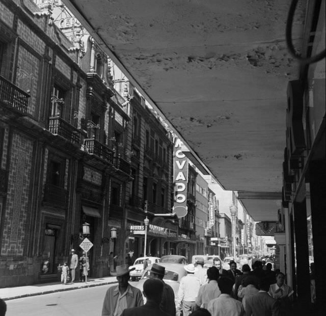 Pedestrians walk down sidewalks in downtown Mexico City.