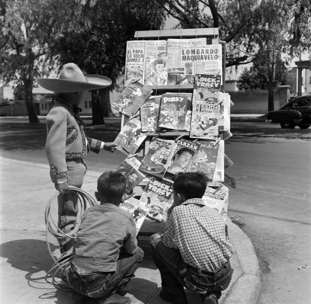 Three little boys look a comic books on a news stand in Mexico City.