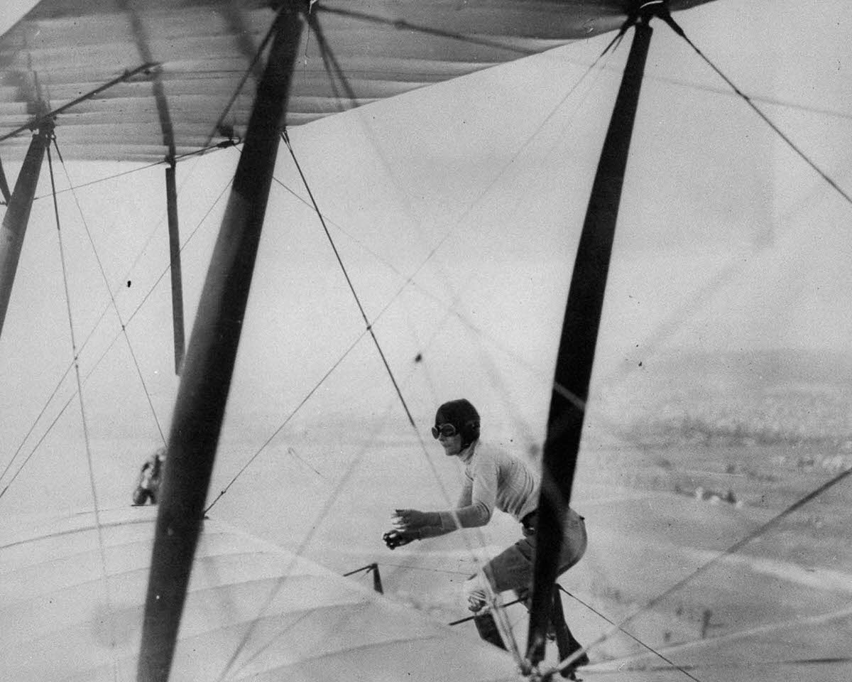 Gladys Engle balances atop a biplane, 1926.